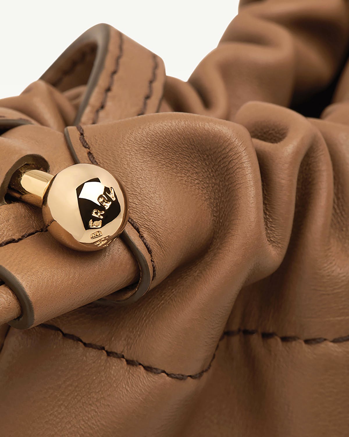 Clay leather drawstring with ruched leather and gold ball fastener