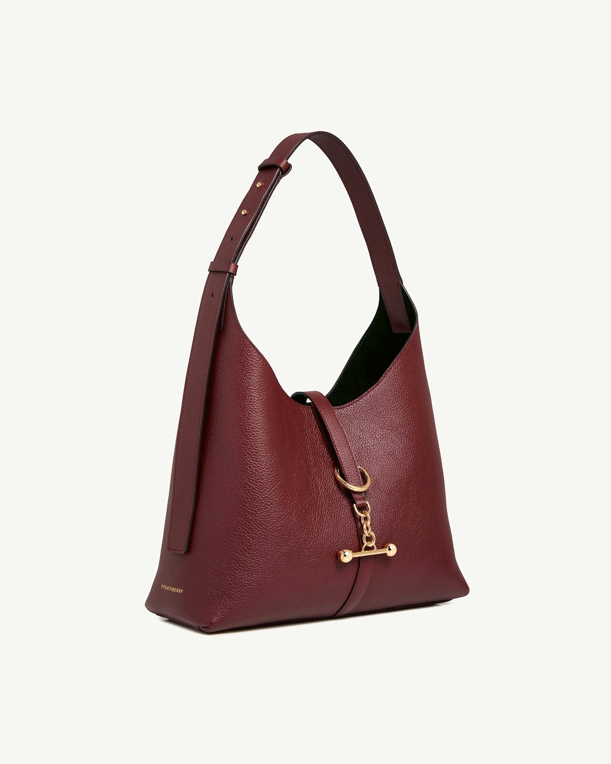 Oxblood Kite Hobo leather bag with shoulder strap, gold toggle and Strathberry logo.