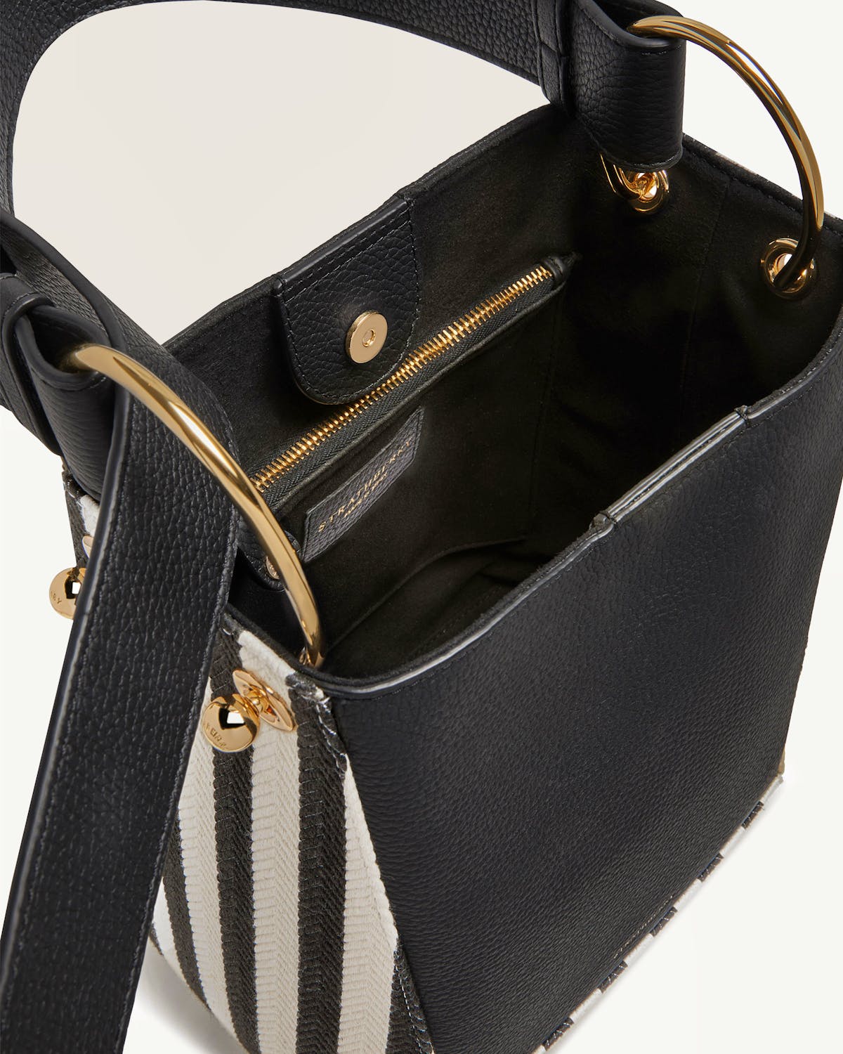 Lana midi bucket bag striped canvas with black leather panels and gold hardware, interior view