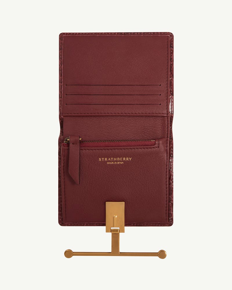 Strathberry Melville Street Wallet croc in burgundy, open showing card slots and gold clasp