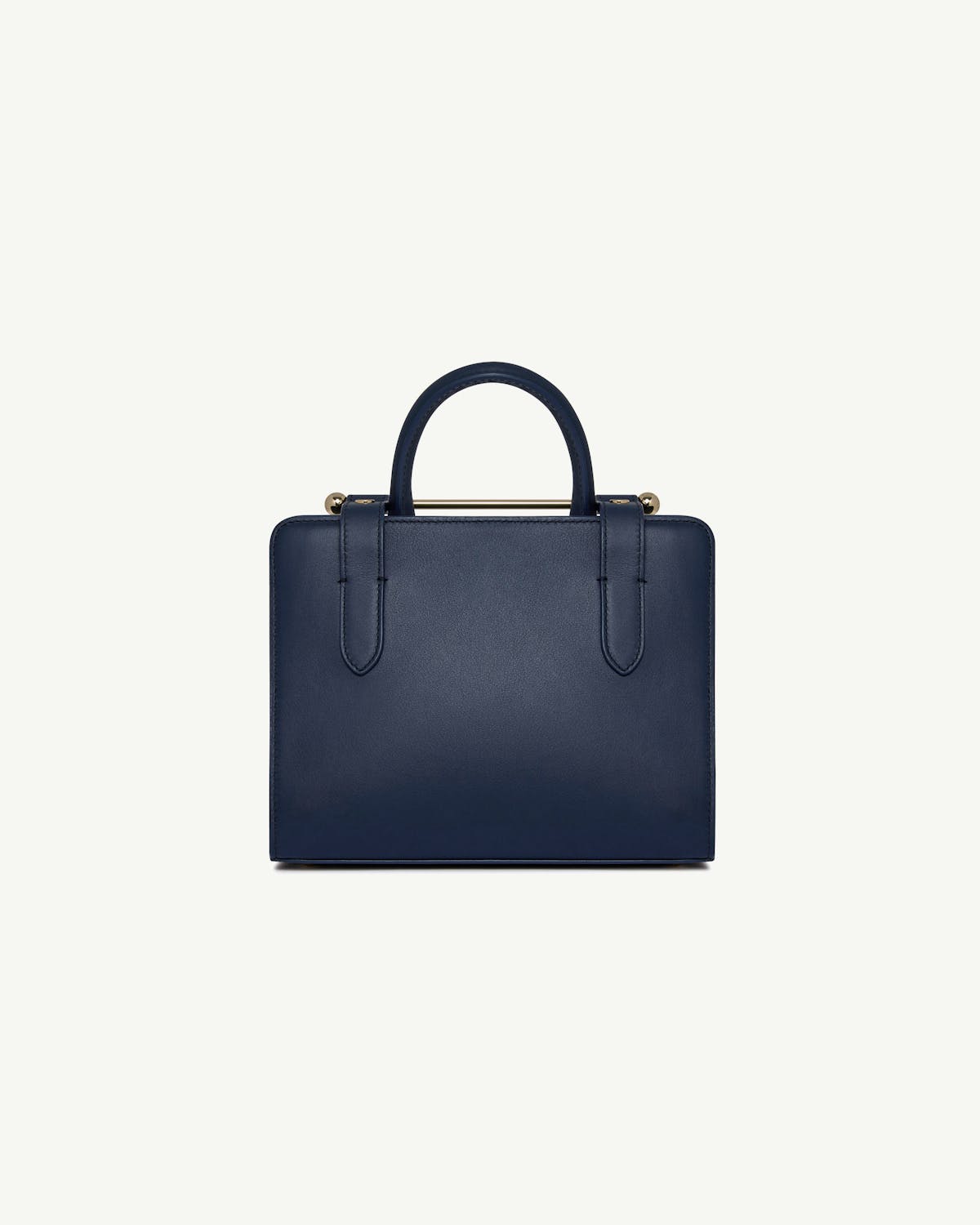 Marine blue mini tote bag front with top handles and gold bar detail.