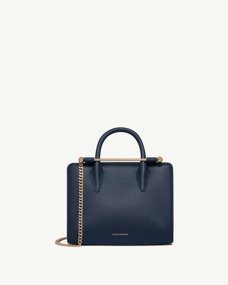 Strathberry marine blue mini tote with gold bar and chain strap
