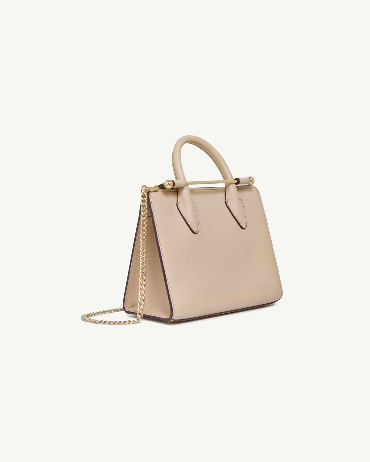 Oat mini tote with top handles and gold chain strap, angled front view