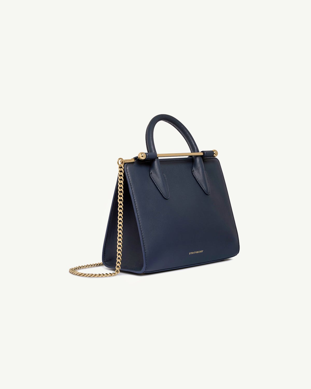 Strathberry marine blue mini tote with top handle and gold chain strap