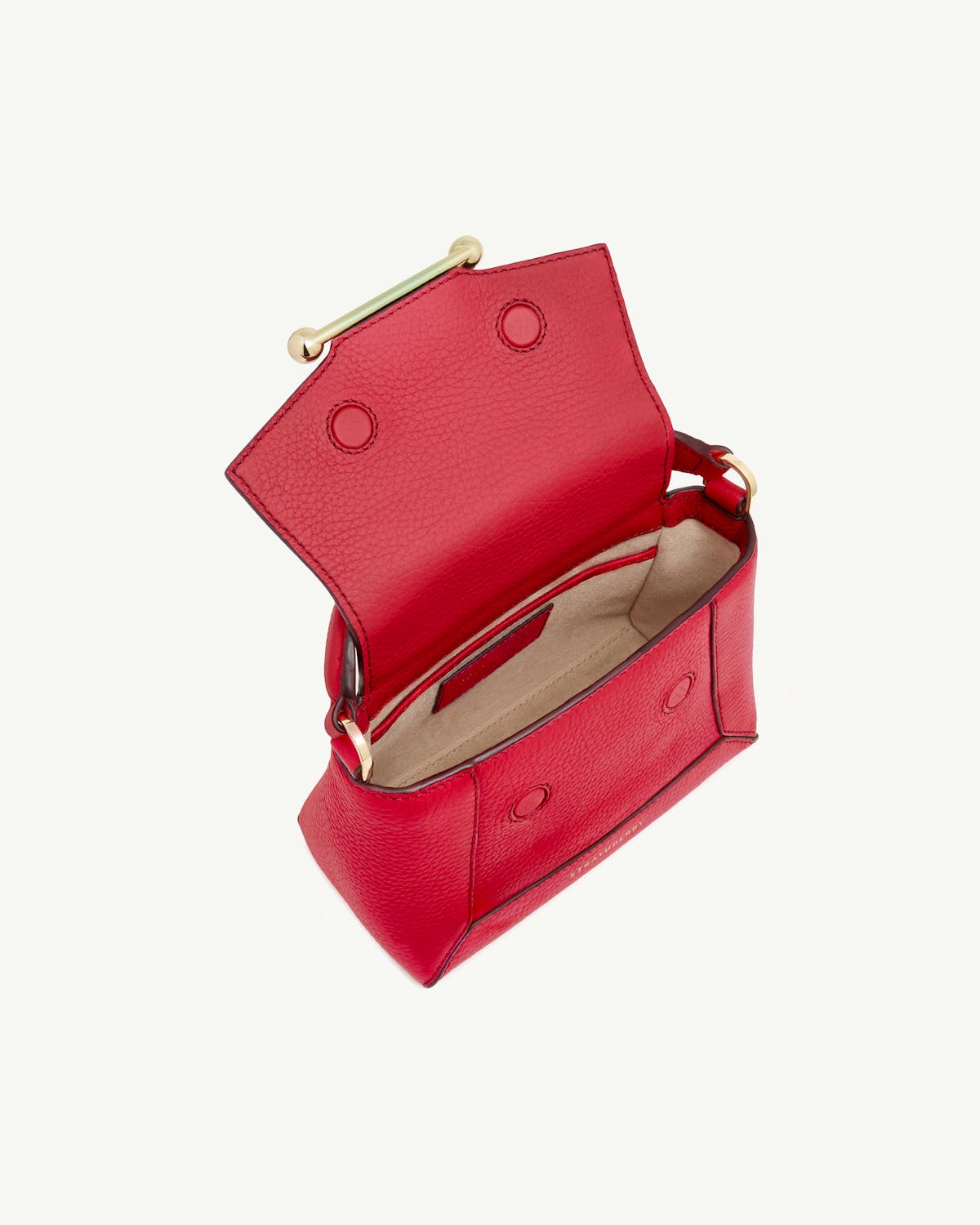 Raspberry leather mini bag open showing beige interior and gold bar hardware