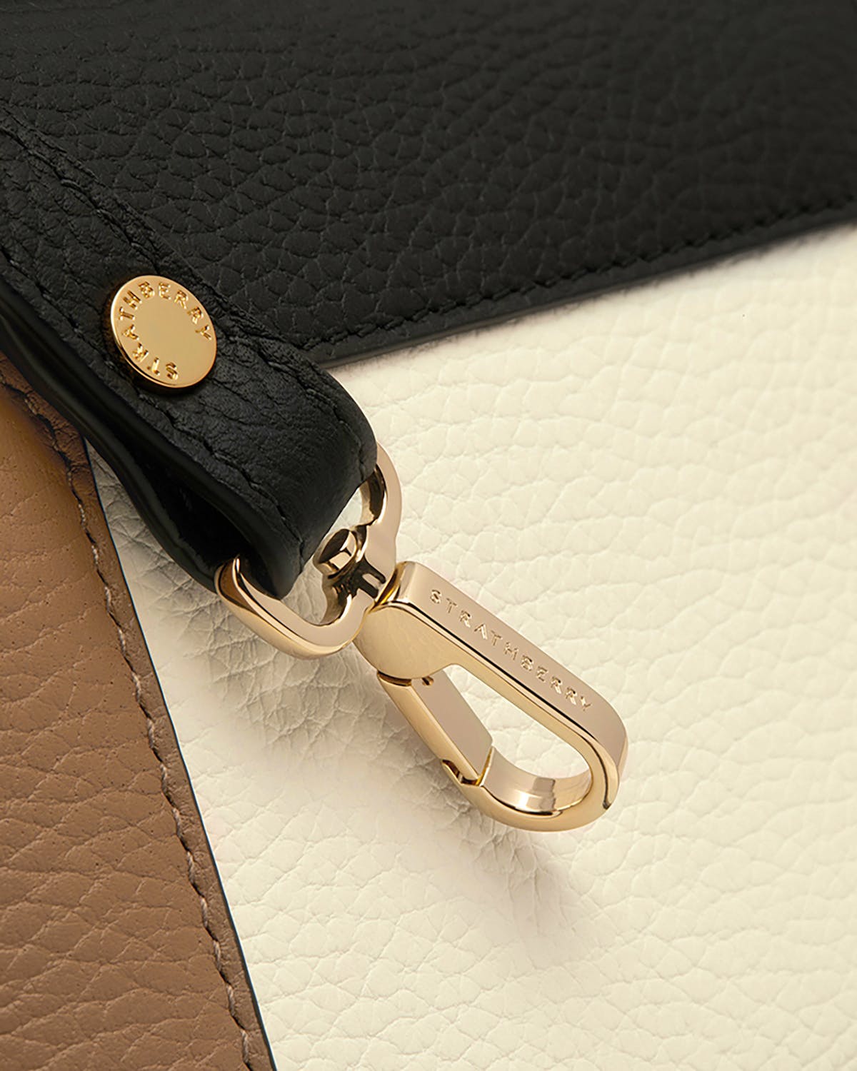 Gold clasp engraved Strathberry on black, white and clay pebbled leather