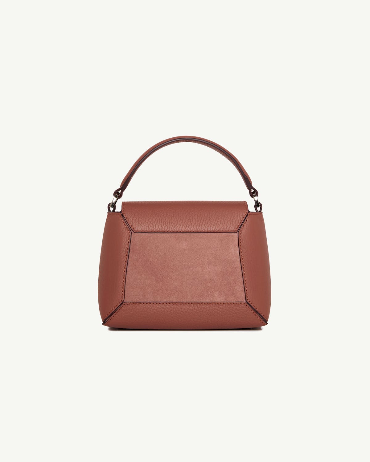 Small sienna and dusty pink suede top-handle bag with geometric stitched panels.