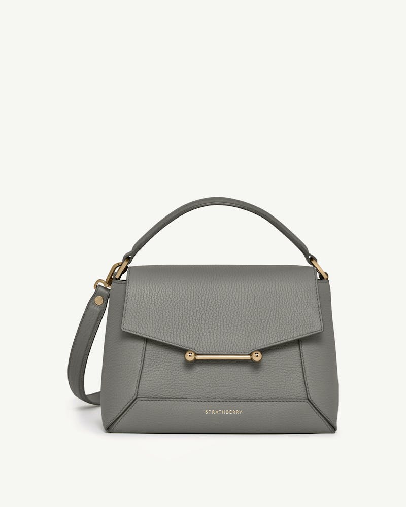 Strathberry stone grey mosaic bag with top handle, gold bar closure and detachable strap.