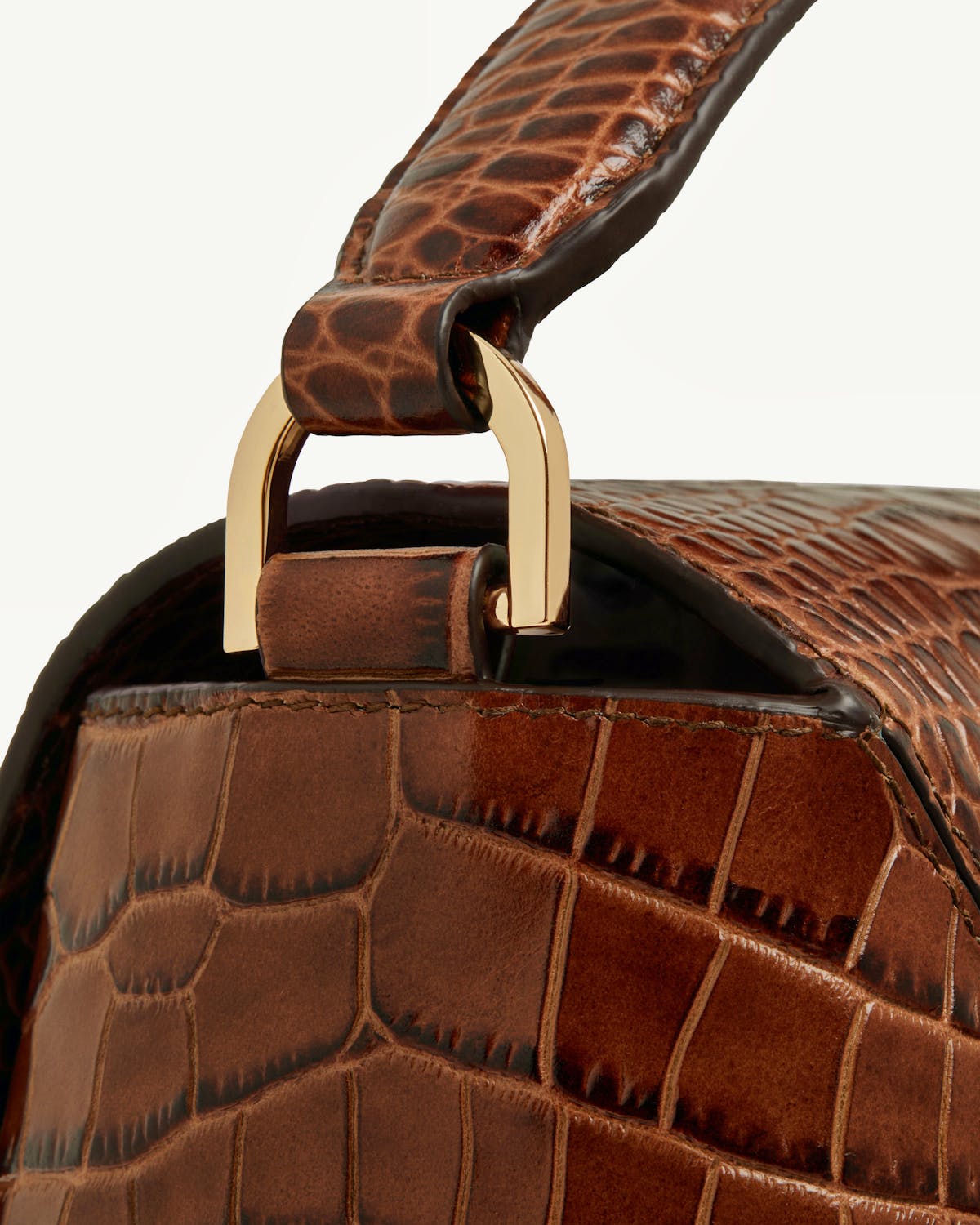 Close-up of soft croc mosaic bag side with gold handle hardware
