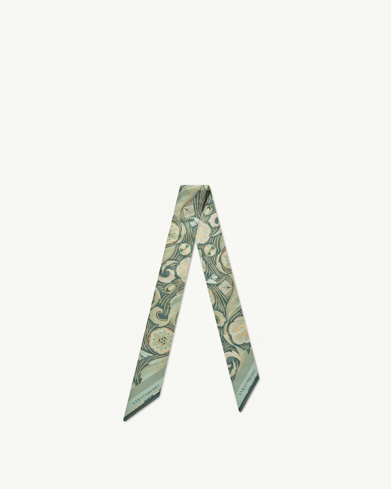 Sage silk skinny scarf with arcade floral print and visible Strathberry wordmark.