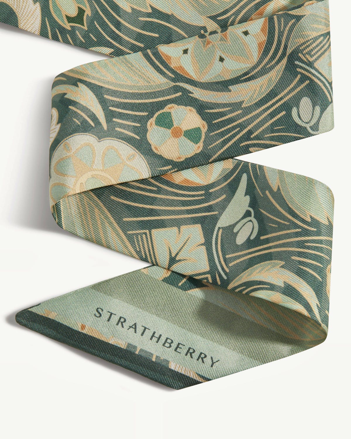 Sage silk skinny scarf with arcade print and visible Strathberry wordmark.