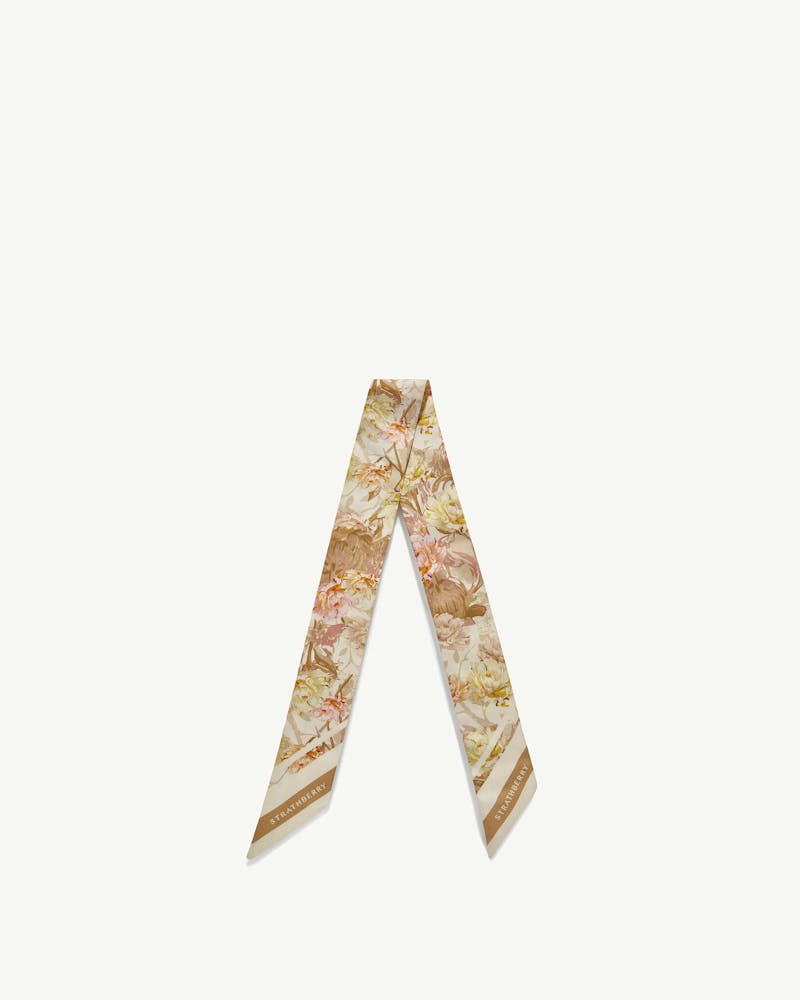 Floral print vanilla and pink skinny silk scarf with Strathberry logo at ends.