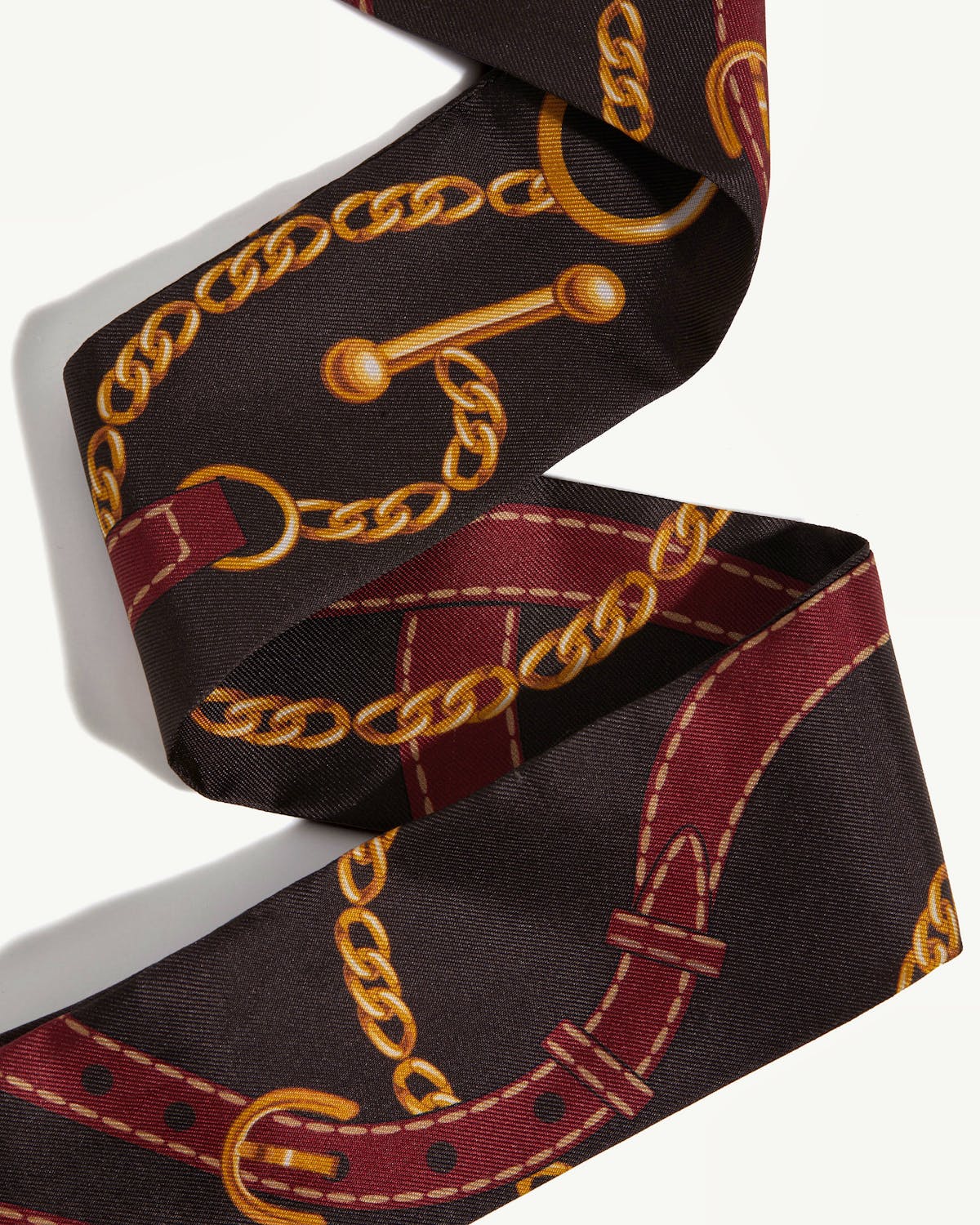 Oxblood and espresso skinny silk scarf with belt and chain print.