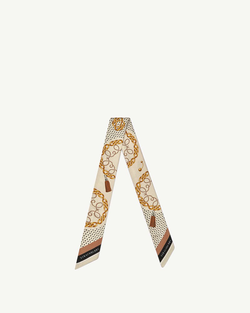 Cream silk skinny scarf with tan chain and black polka dot print, Strathberry wordmark