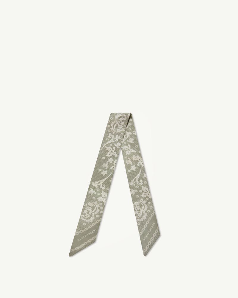 Sage silk skinny scarf with white lace print and Strathberry wordmark