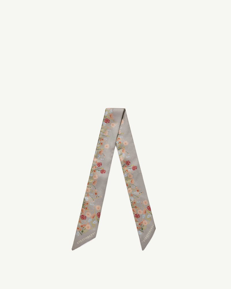 Marble grey silk skinny scarf with frame flower print and Strathberry logo.