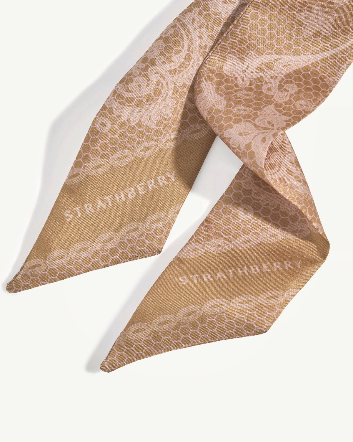 Rose lace silk skinny scarf with Strathberry logo, folded on white background