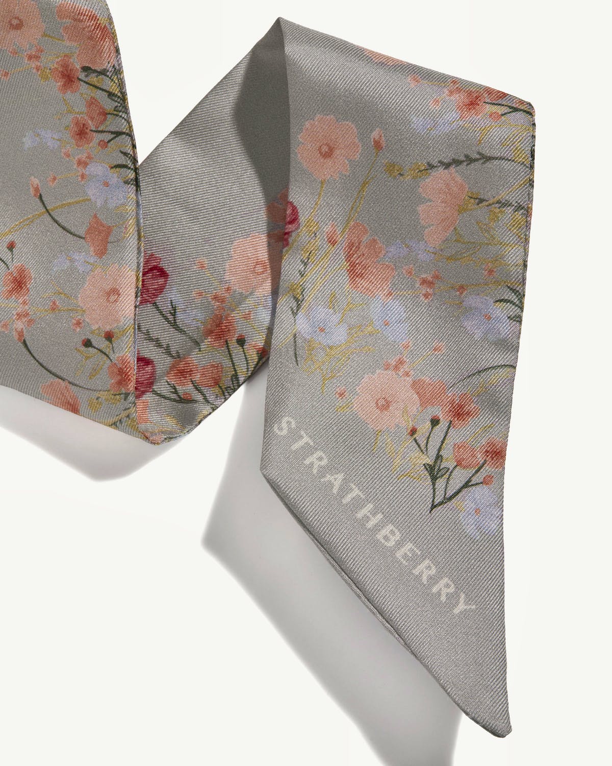 Marble grey silk skinny scarf with pink floral print and Strathberry logo.