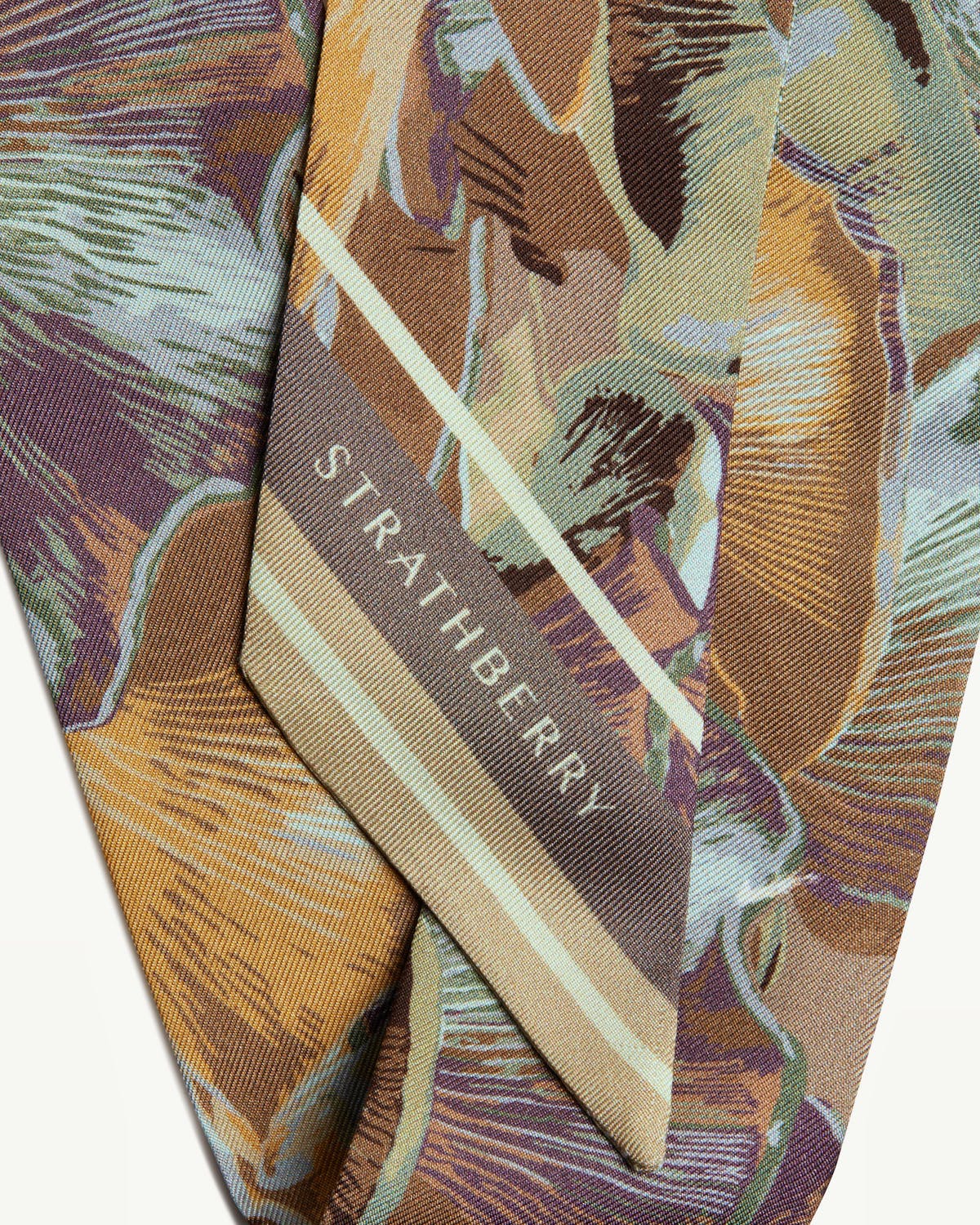 Silk skinny scarf in oat and mushroom print with STRATHBERRY logo visible.