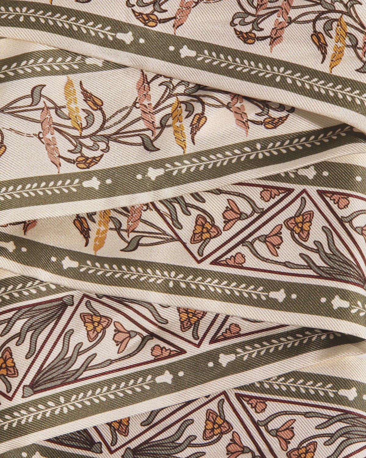 Folded silk skinny scarf with geometric floral pattern in vanilla and sage.
