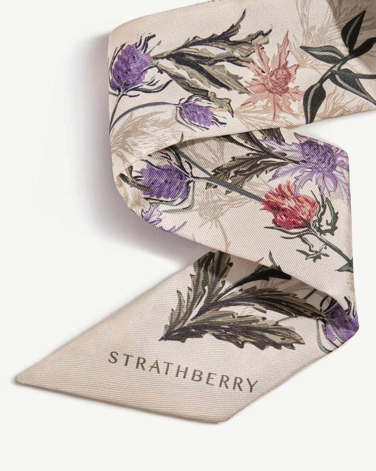 Vanilla silk skinny scarf with forest green thistle print and Strathberry logo.