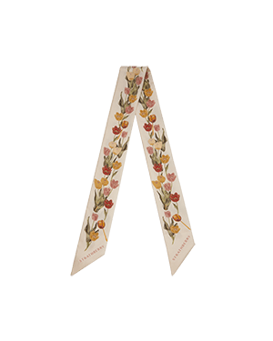 Vanilla silk skinny scarf with brûlée tulip print, folded into a V.