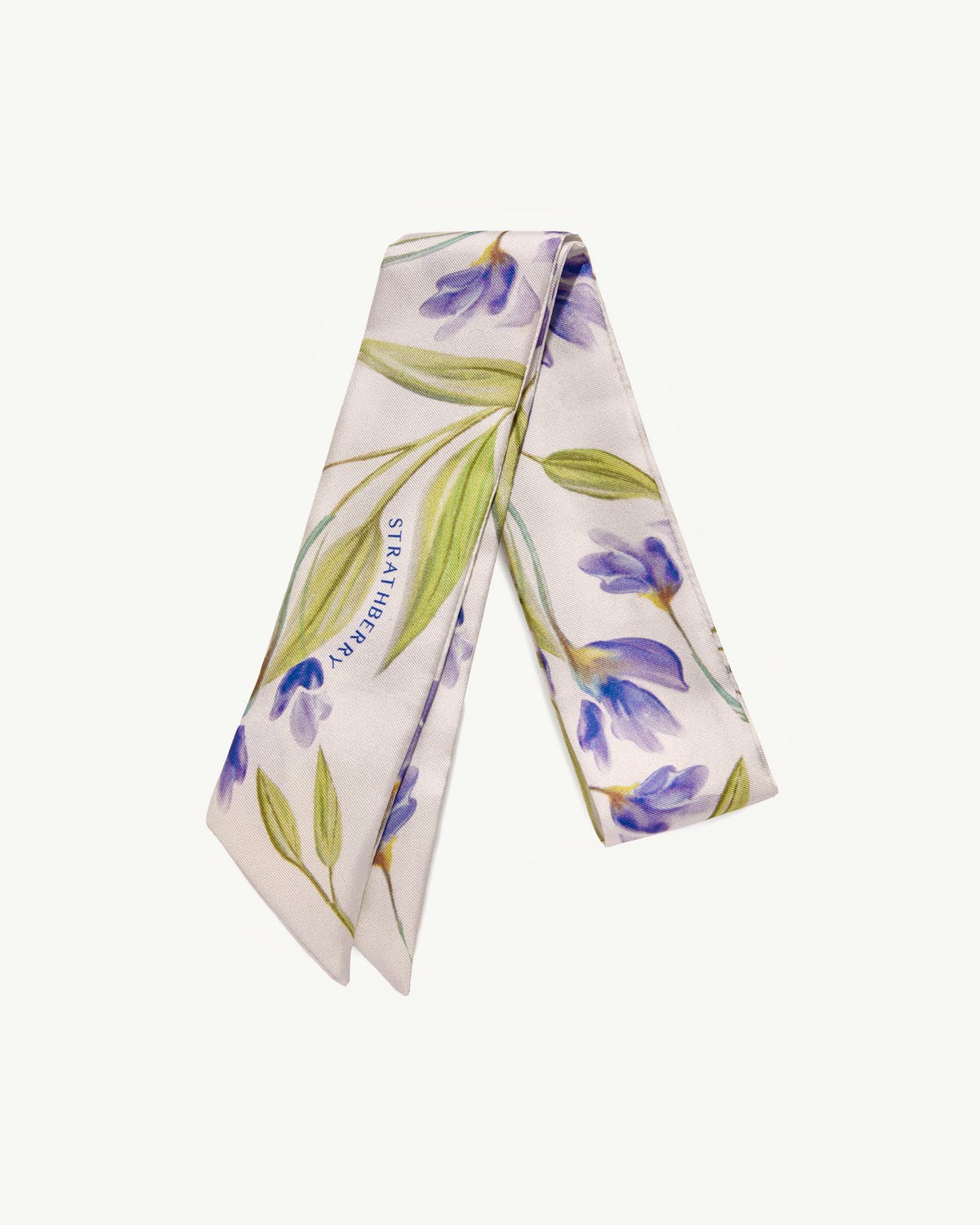 Vanilla silk skinny scarf with true blue watercolour florals and visible Strathberry logo.
