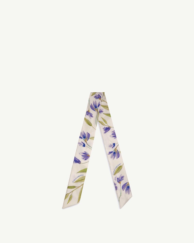 Vanilla silk skinny scarf with blue watercolour floral print and Strathberry logo.