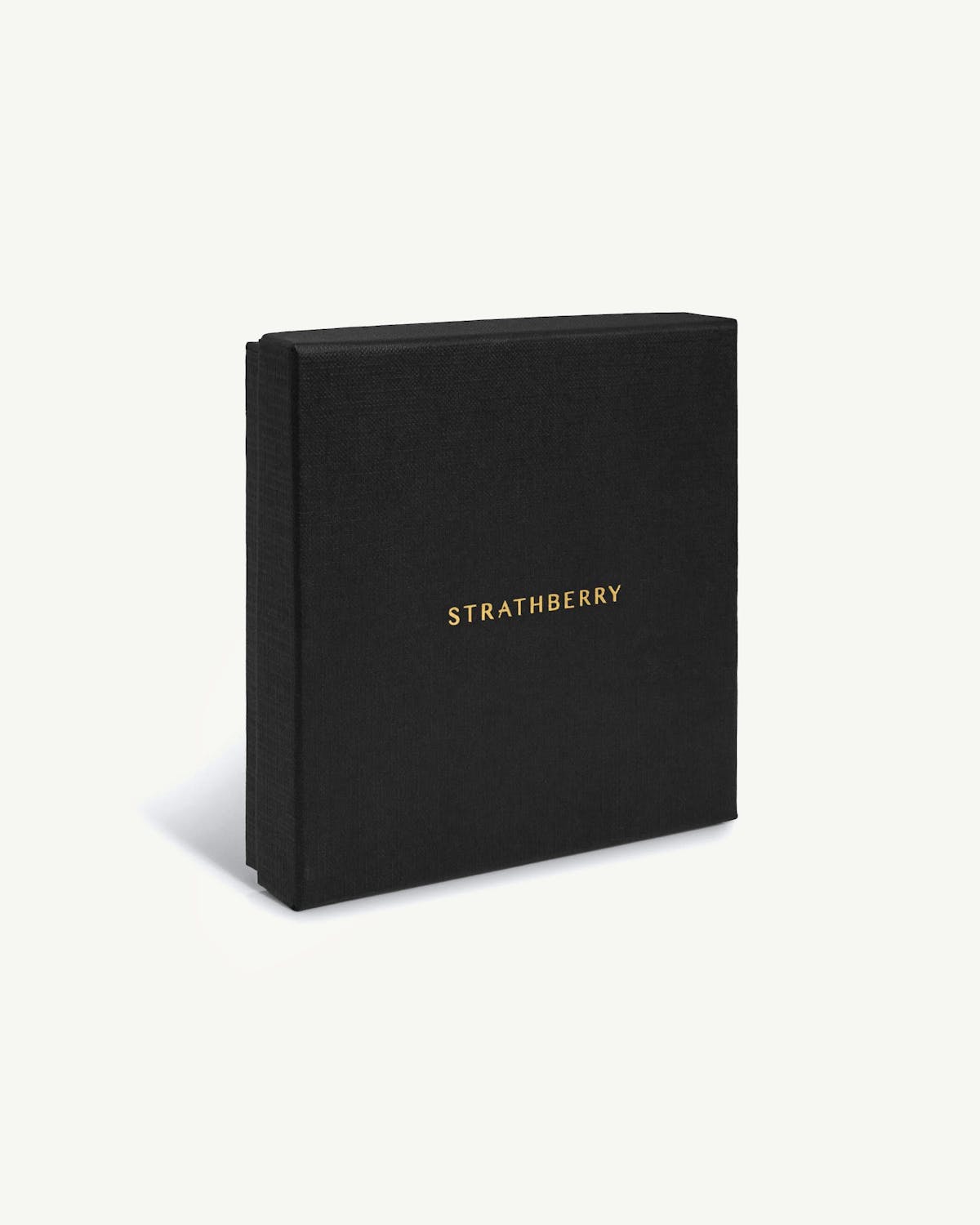 Strathberry black box with gold logo on white background, wallet packaging.