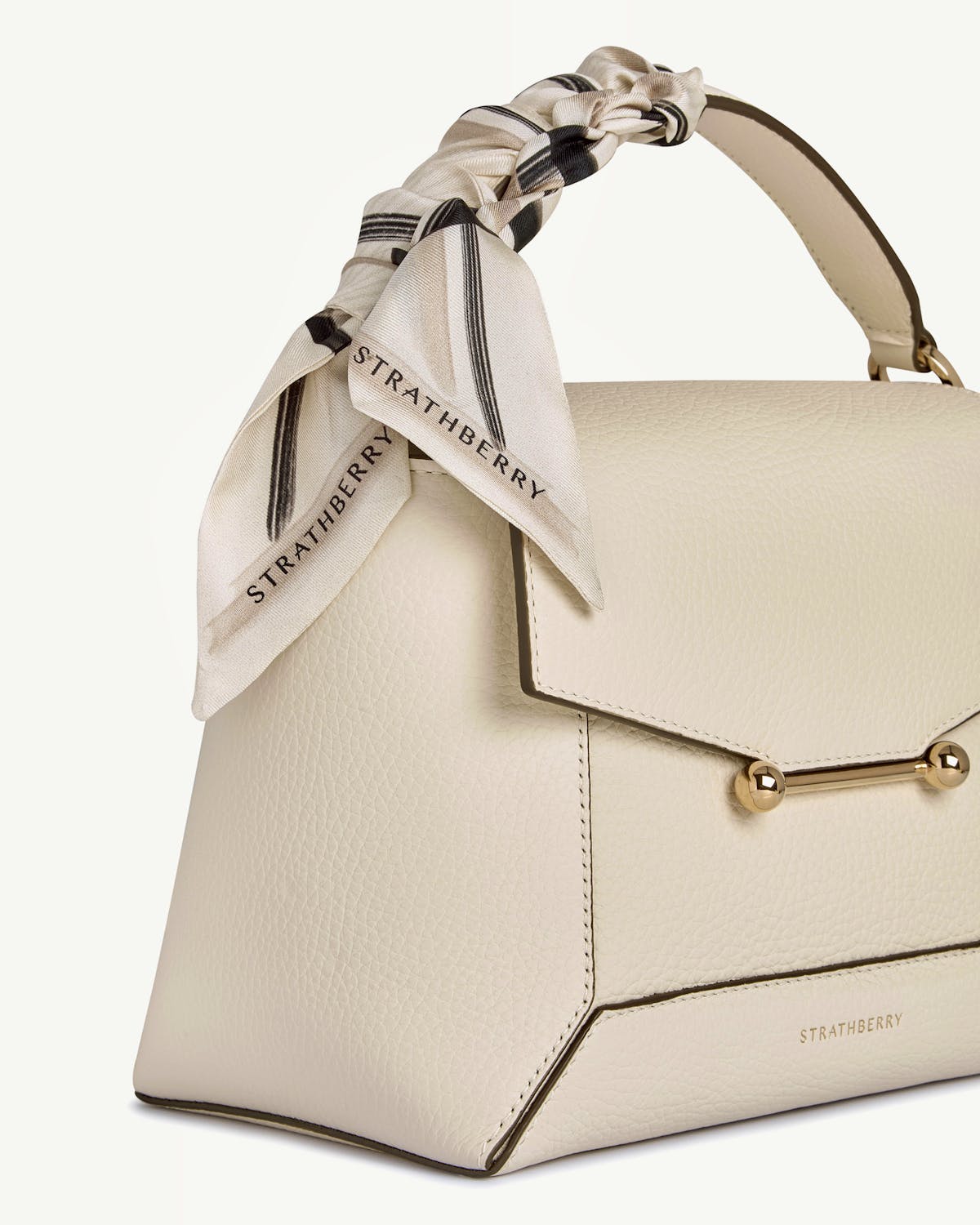 Sand and vanilla tartan silk skinny scarf tied to Strathberry cream-coloured leather bag.