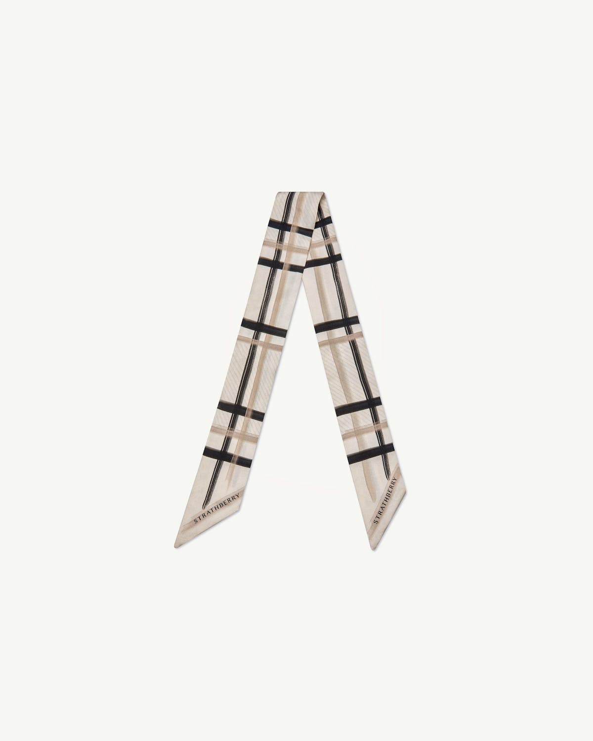 Sand and vanilla tartan silk skinny scarf laid in a V shape with Strathberry logo.
