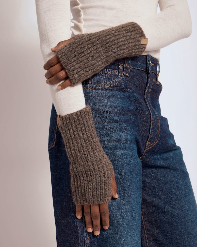 Ember wrist warmers in otter worn with cream top and blue jeans