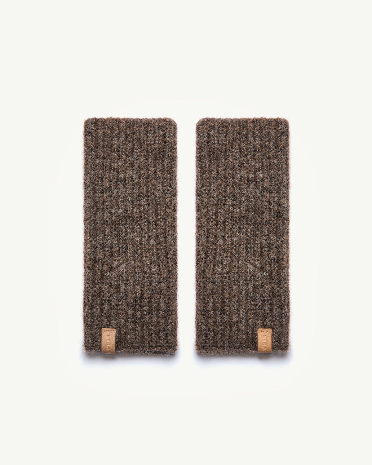 Otter brown Ember wrist warmers with leather Strathberry tags on white background.