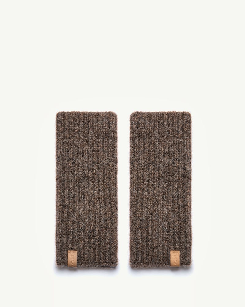 Strathberry Ember wrist warmers in otter laid flat on white background.