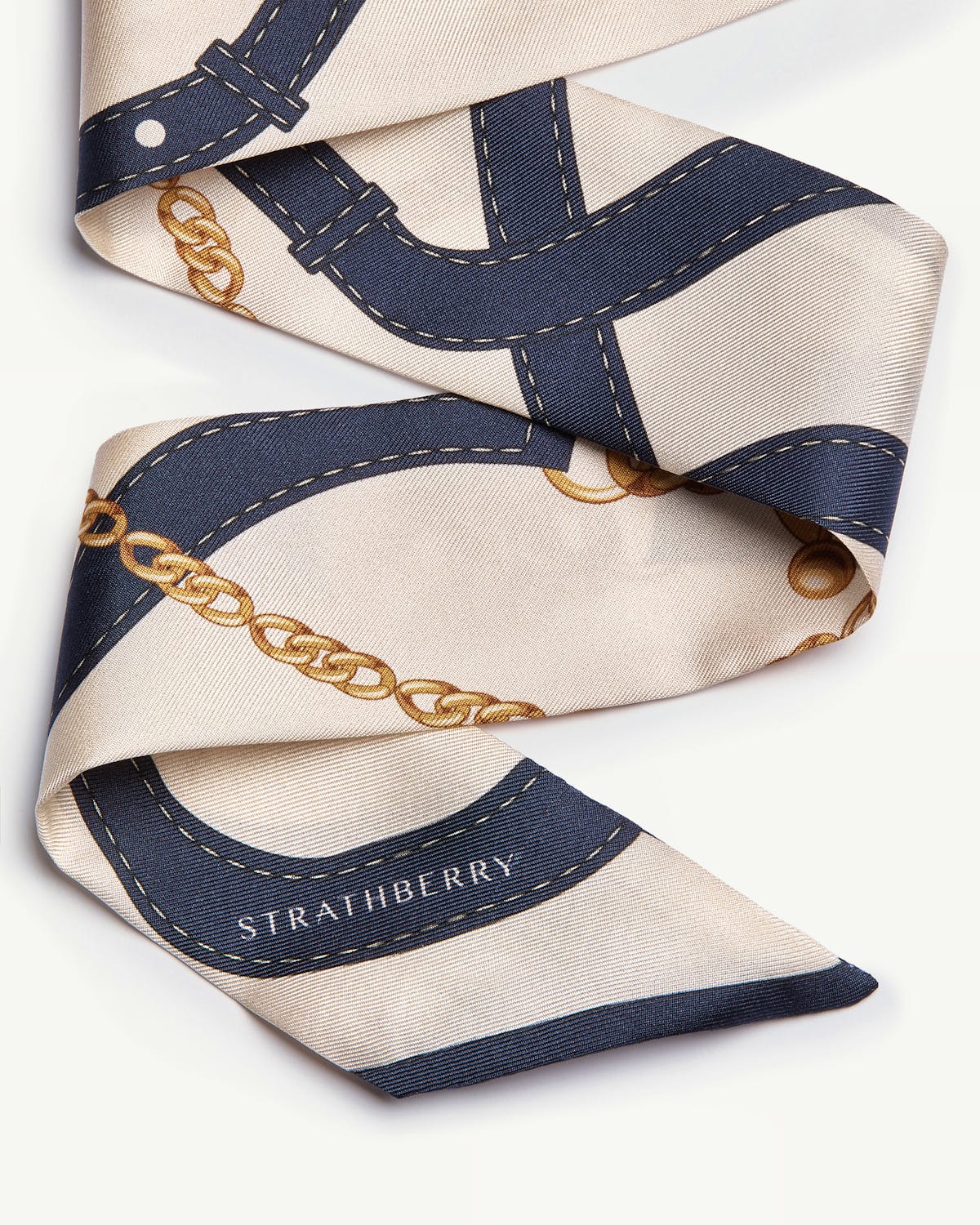 Navy and vanilla silk skinny scarf with belt and chain print, Strathberry logo.