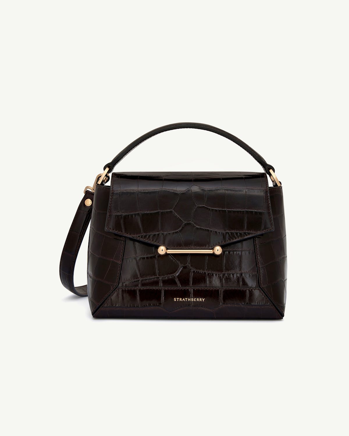Dark brown croc bag with top handle, shoulder strap, gold bar fastening, Strathberry logo.