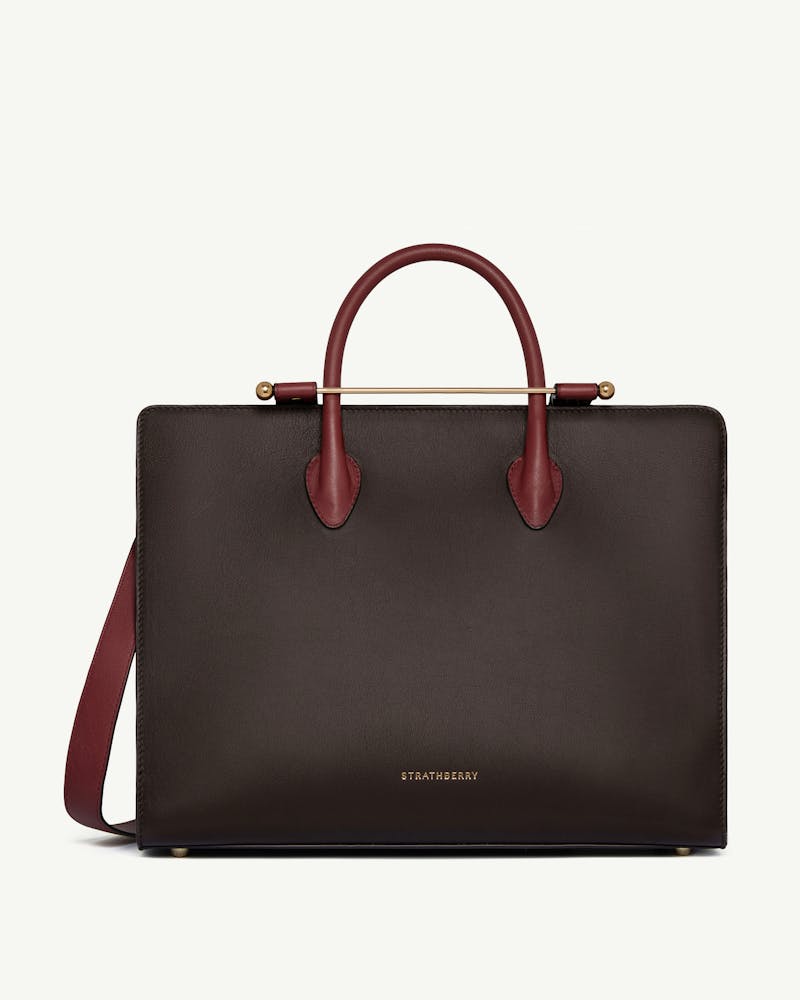 Strathberry tote in espresso with oxblood handles, strap and black trim.