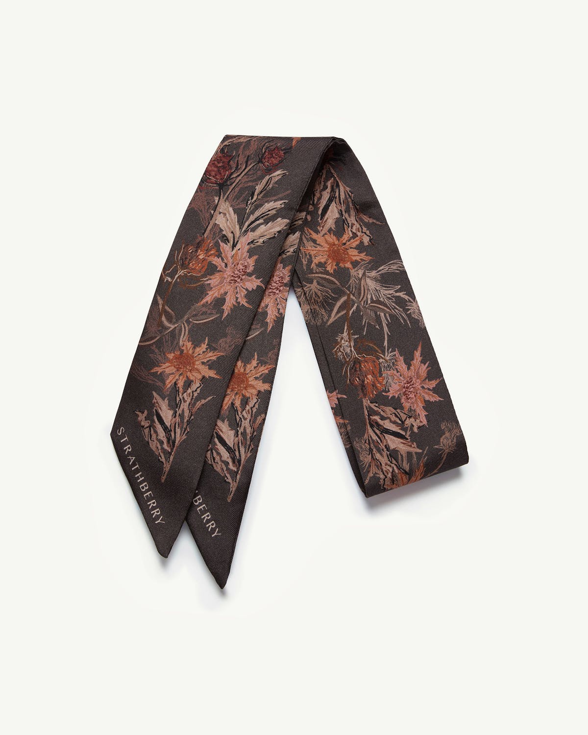 Espresso thistle print silk skinny scarf folded on a white background, Strathberry logo visible.