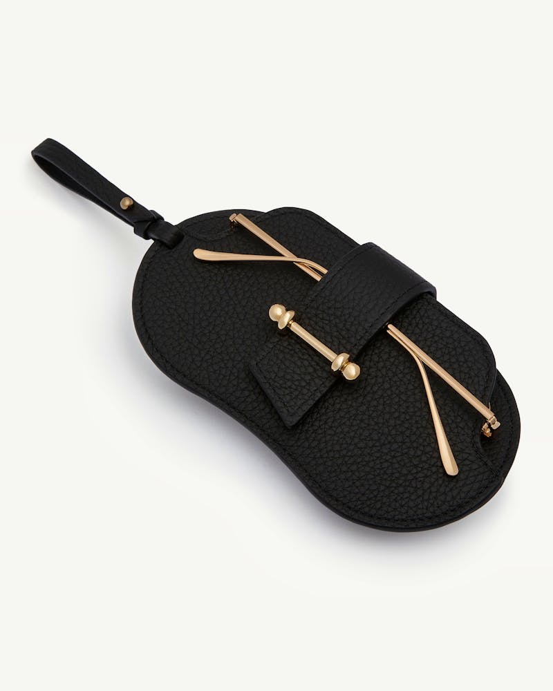 Black pebbled sunglasses case with strap and gold-tone bar hardware.