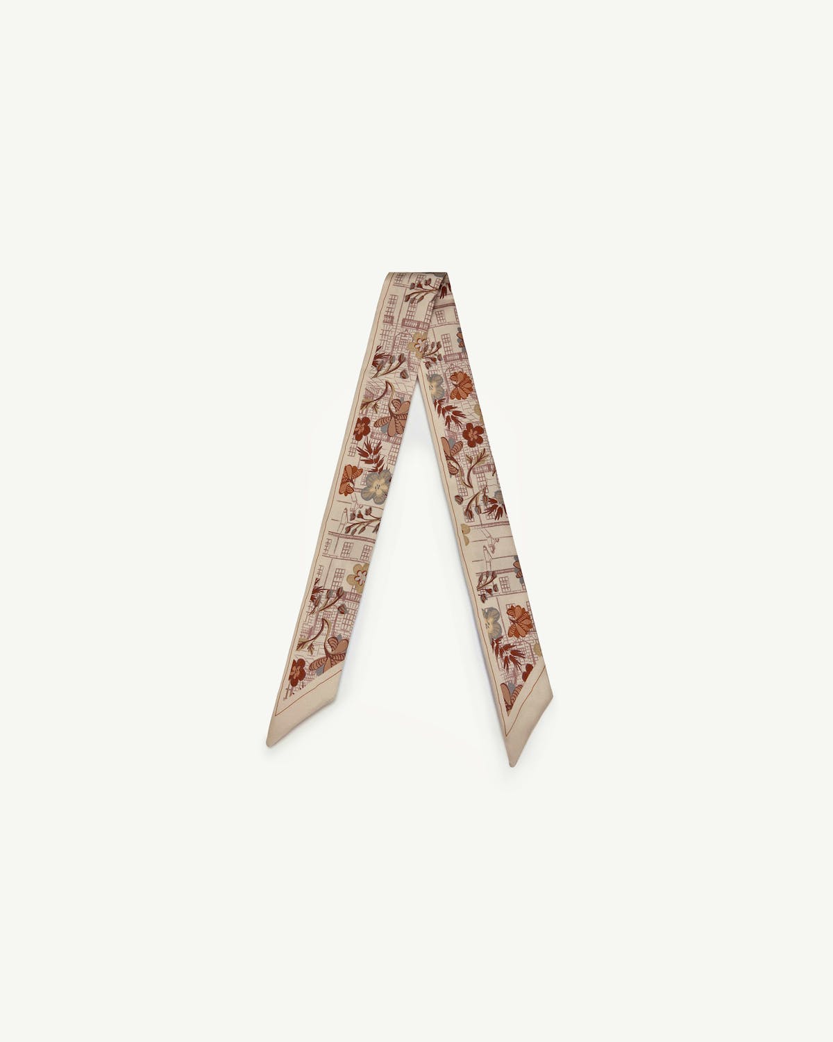 Beige silk skinny scarf with brown floral and townhouse print, folded into a V