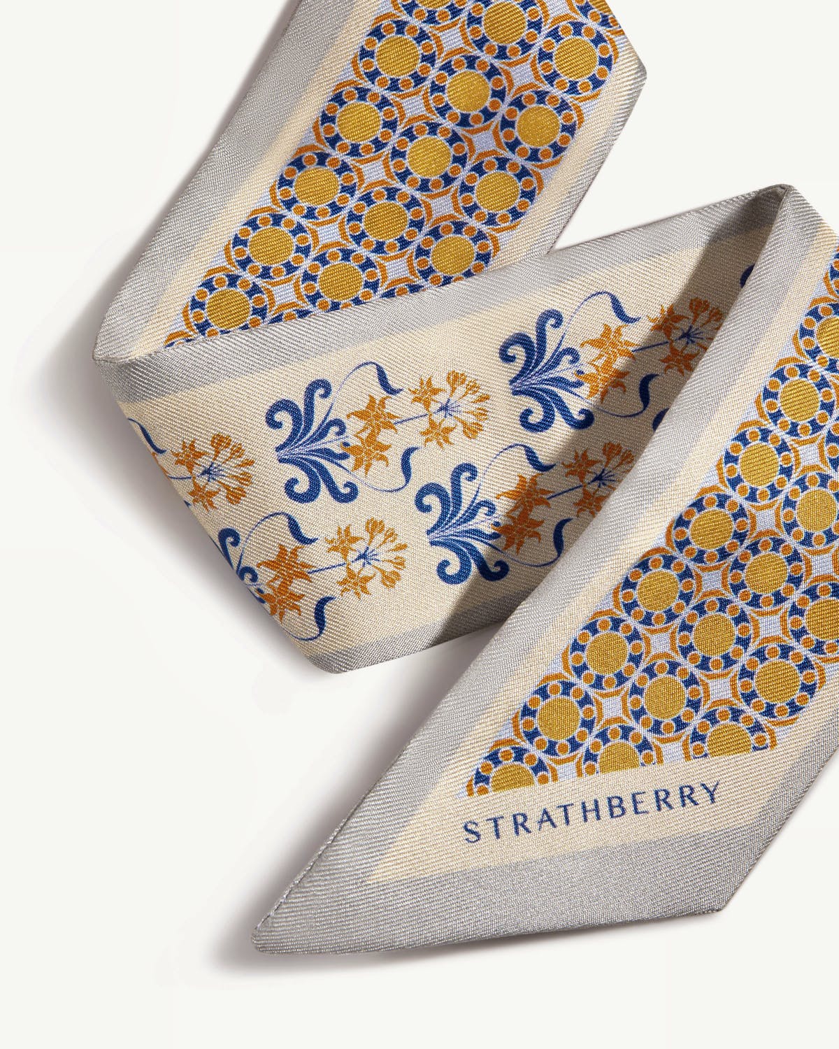 Silk skinny scarf with geometric tile and floral motifs in marble grey and brûlée, Strathberry