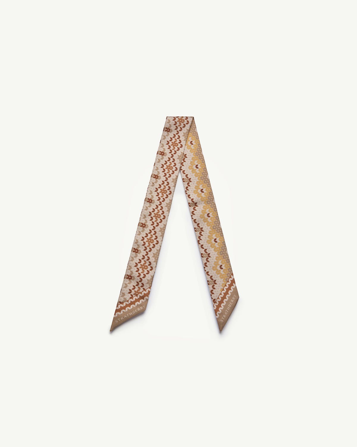 Strathberry silk skinny scarf in brûlée Fair Isle pattern, folded into a V.