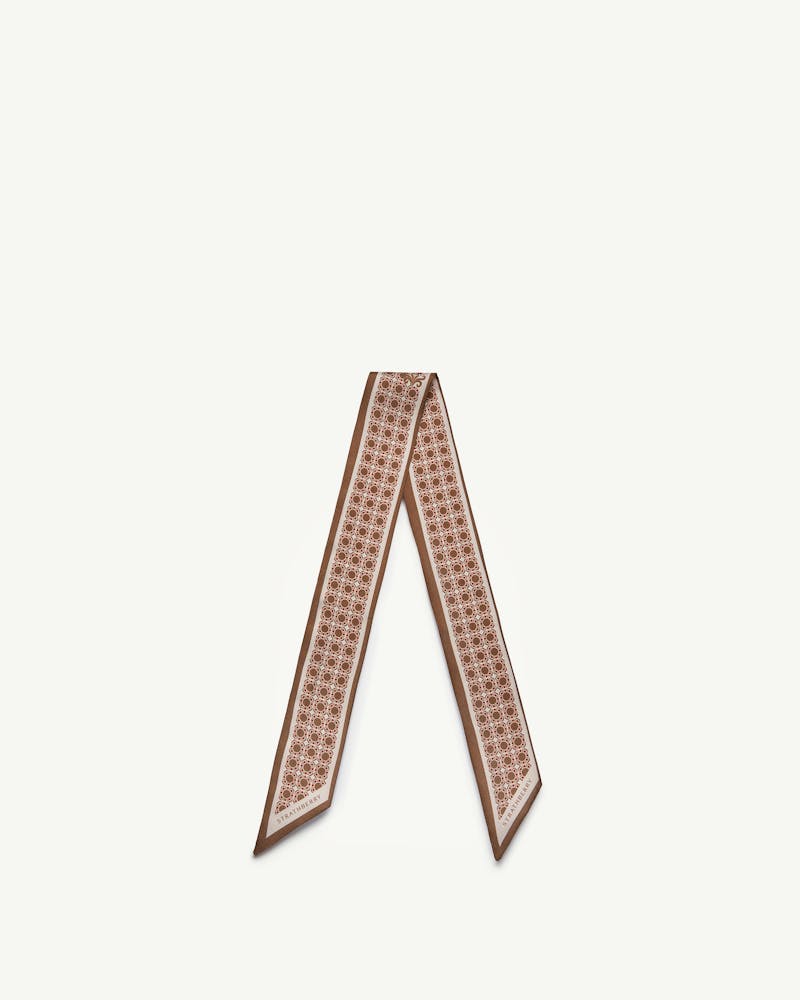 Tan silk skinny scarf with geometric print and Strathberry wordmark at ends.