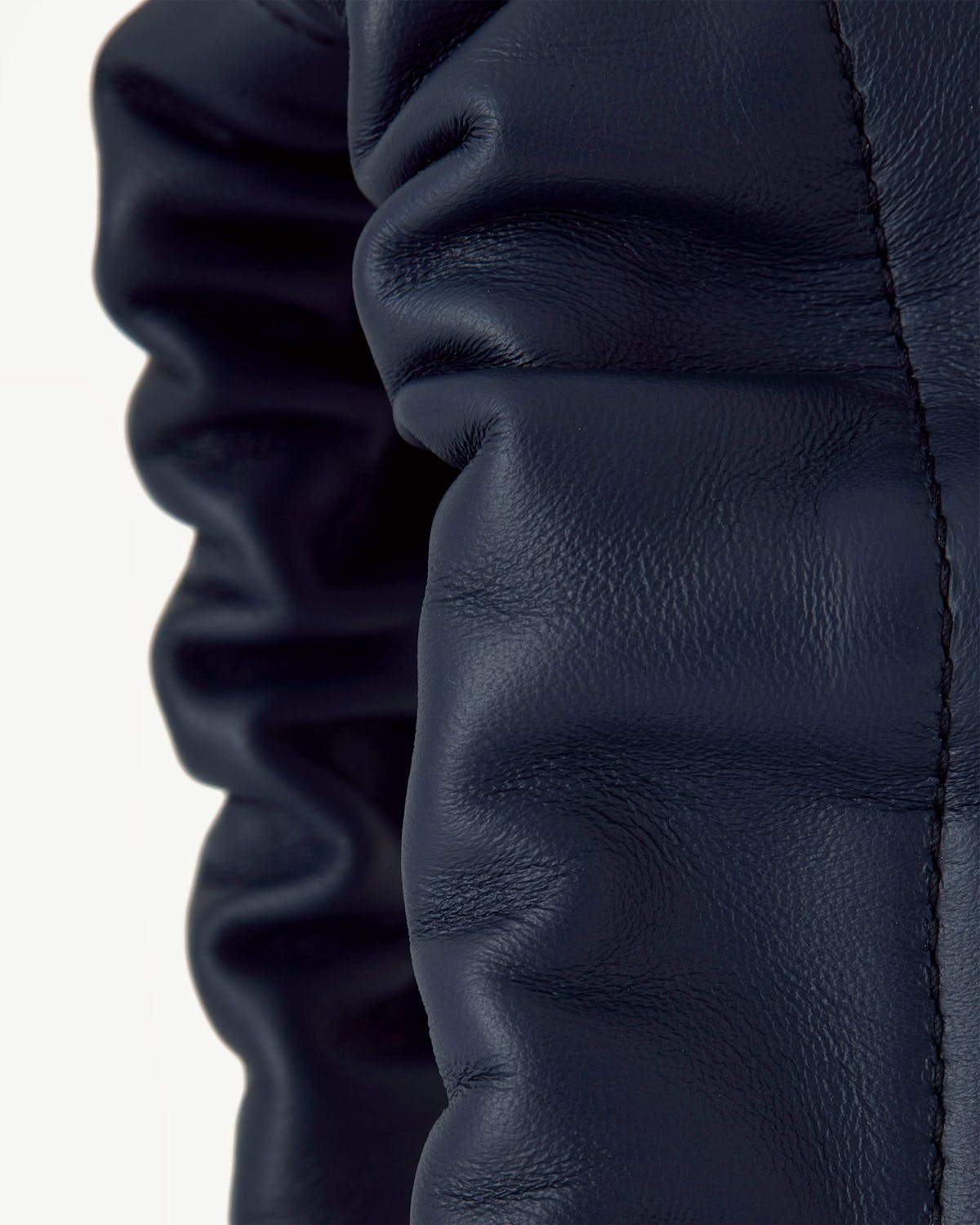 Marine blue leather drawstring bag ruched detail with stitched seam visible