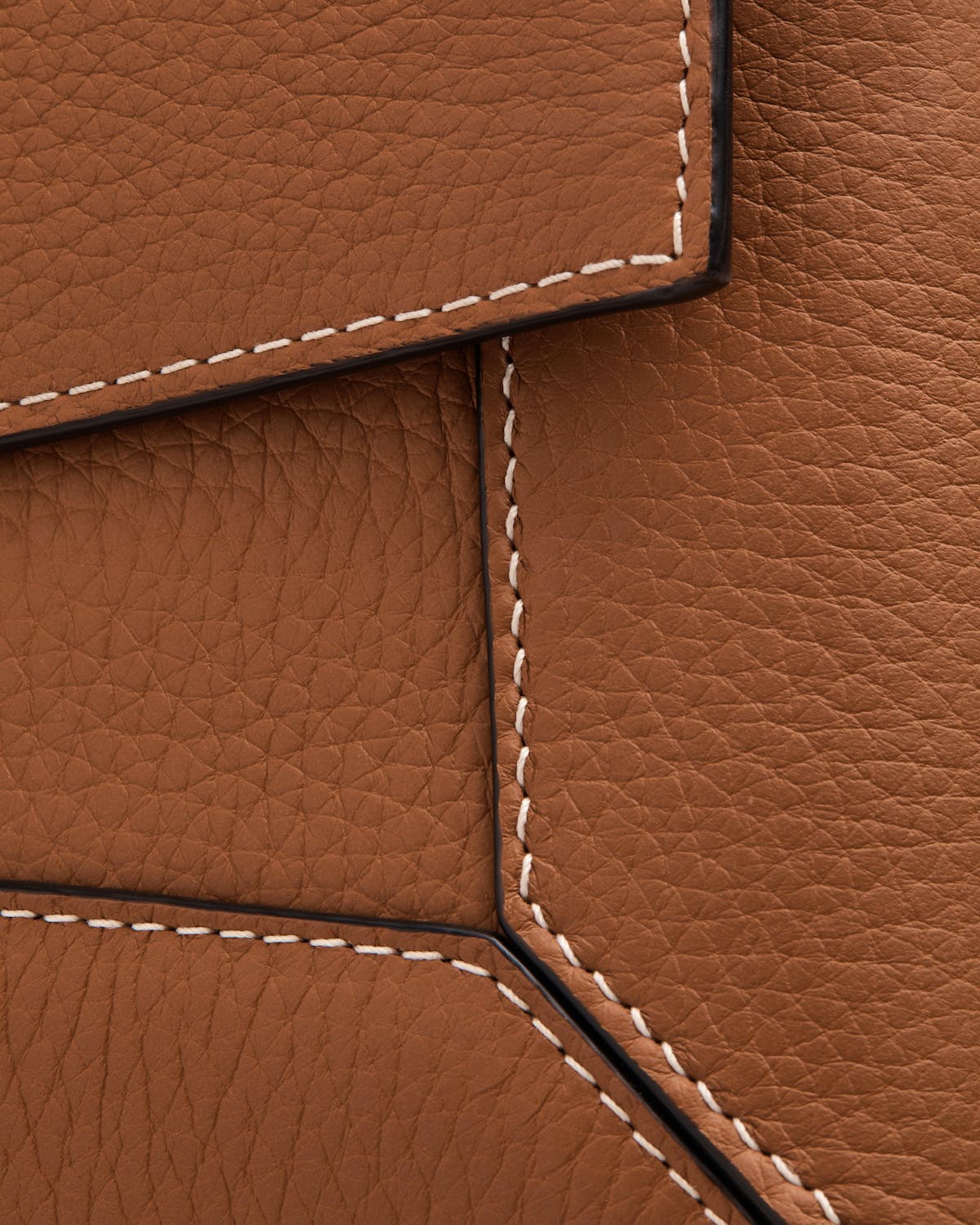 Tan pebbled leather mosaic panels with white contrast stitching on shoulder bag.