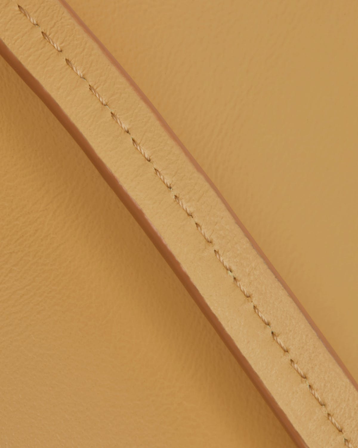 Brûlée leather strap and leather panel showing stitched edge and smooth grain