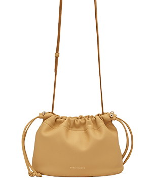 Strathberry Charlotte drawstring bag in brûlée leather with long shoulder strap and logo.