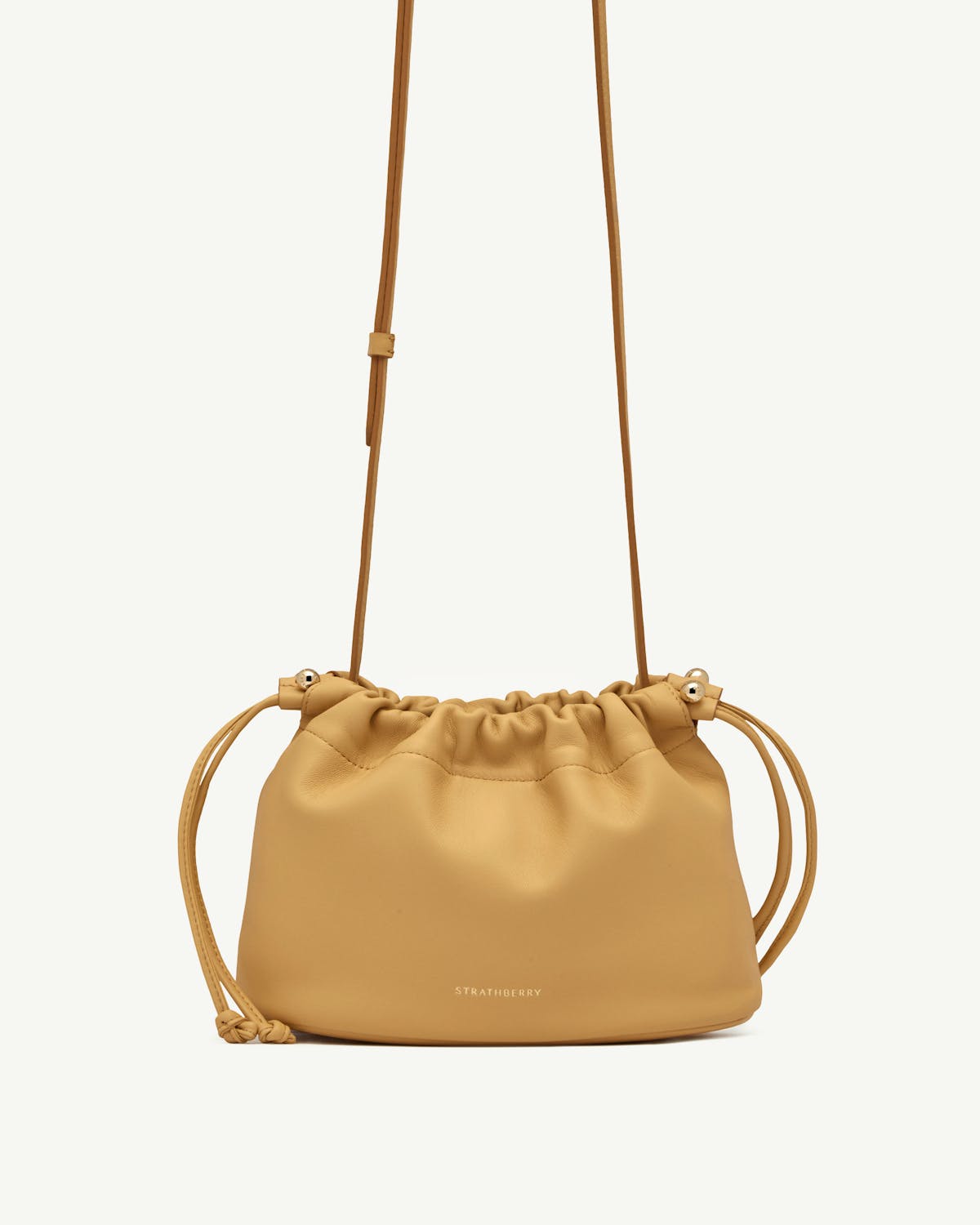 Strathberry Brûlée Charlotte drawstring bag with adjustable shoulder strap and front logo