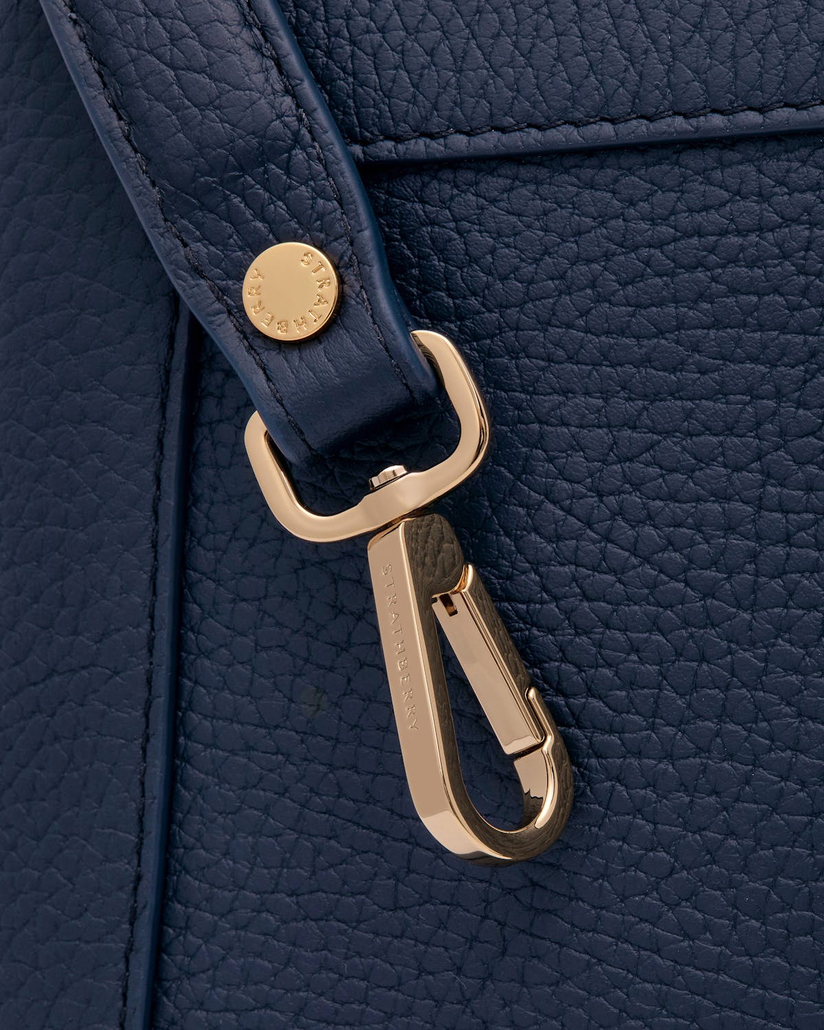 Navy Mosaic bag pebbled leather and gold Strathberry clasp hardware.