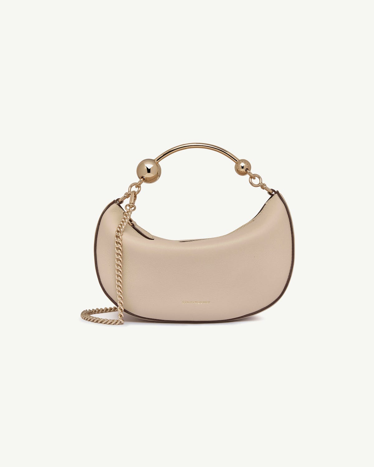 Strathberry Crescent Moon Mini bag in oat with gold hoop handle and chain.